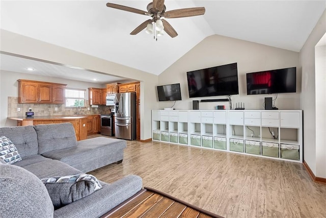 601 W 3rd Ter, Wellsville, KS 66092 - living room featuring light wood-style flooring, a ceiling fan, vaulted ceiling, baseboards, and recessed lighting