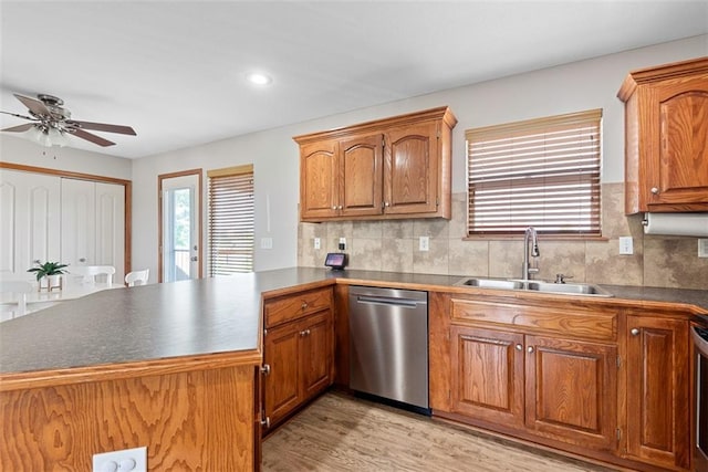 601 W 3rd Ter, Wellsville, KS 66092 - kitchen featuring dishwasher, a sink, a peninsula, ceiling fan, and light wood-style flooring