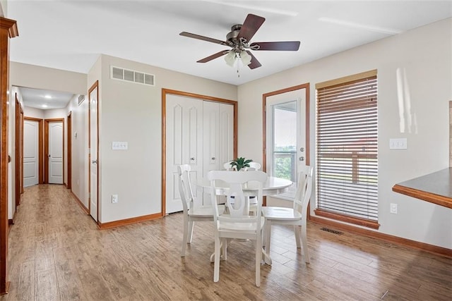 601 W 3rd Ter, Wellsville, KS 66092 - dining space with baseboards, light wood-style floors, and ceiling fan