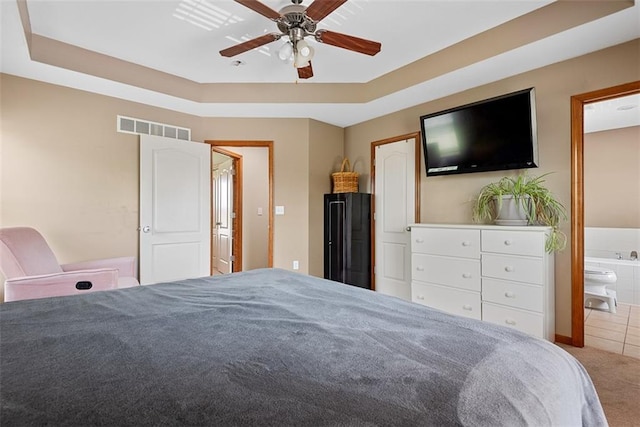 601 W 3rd Ter, Wellsville, KS 66092 - carpeted bedroom featuring a tray ceiling, ceiling fan, and ensuite bath