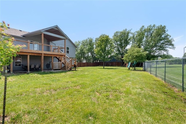 601 W 3rd Ter, Wellsville, KS 66092 - view of yard with stairs, a wooden deck, and a playground