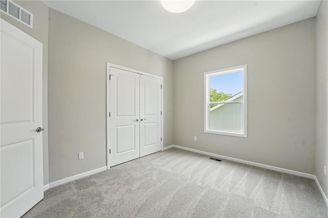 801 Highland Dr, Edwardsville, KS 66111 - unfurnished bedroom featuring carpet floors, baseboards, and a closet