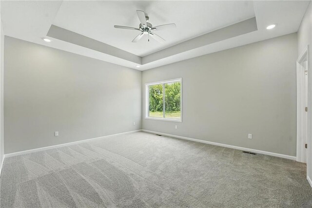 801 Highland Dr, Edwardsville, KS 66111 - carpeted spare room with baseboards, a ceiling fan, recessed lighting, and a raised ceiling