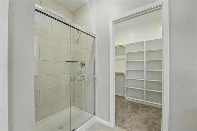 801 Highland Dr, Edwardsville, KS 66111 - full bath with a stall shower, a spacious closet, and baseboards