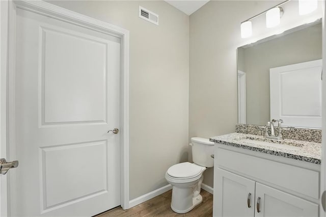 801 Highland Dr, Edwardsville, KS 66111 - bathroom featuring vanity, baseboards, toilet, and wood finished floors