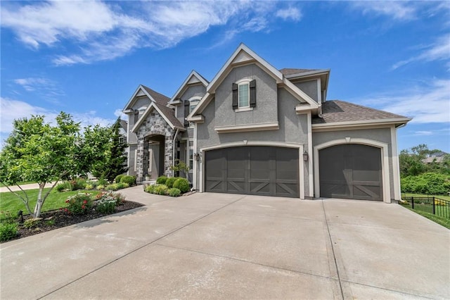 9812 Saddletop St, Lenexa, KS 66227 - view of front of home featuring driveway, stucco siding, a garage, and roof with shingles