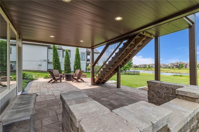 9812 Saddletop St, Lenexa, KS 66227 - view of patio / terrace with a water view, stairway, a fire pit, and a residential view
