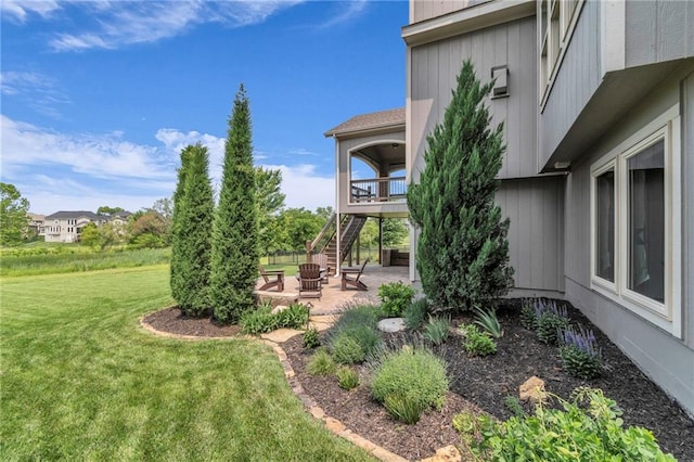 9812 Saddletop St, Lenexa, KS 66227 - view of green lawn with a patio, stairs, and an outdoor fire pit