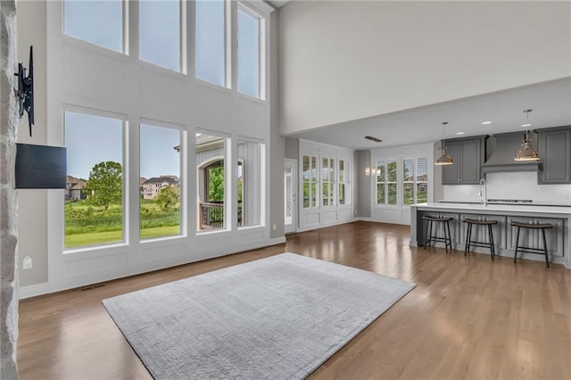 9812 Saddletop St, Lenexa, KS 66227 - living area featuring a towering ceiling and wood finished floors