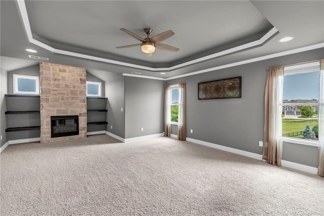 9812 Saddletop St, Lenexa, KS 66227 - unfurnished living room featuring a tray ceiling, ceiling fan, a fireplace, carpet flooring, and recessed lighting