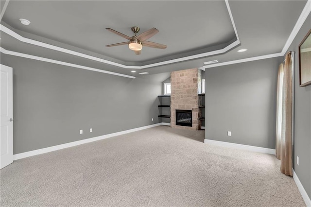 9812 Saddletop St, Lenexa, KS 66227 - unfurnished living room featuring a tray ceiling, ceiling fan, recessed lighting, carpet, and a large fireplace