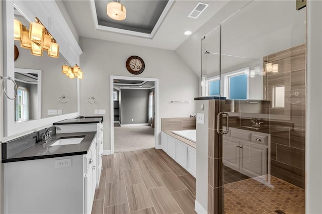 9812 Saddletop St, Lenexa, KS 66227 - full bathroom featuring vanity, a shower stall, a garden tub, lofted ceiling, and wood finished floors