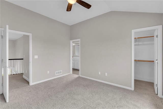 9812 Saddletop St, Lenexa, KS 66227 - unfurnished bedroom featuring a spacious closet, carpet, vaulted ceiling, a closet, and a ceiling fan