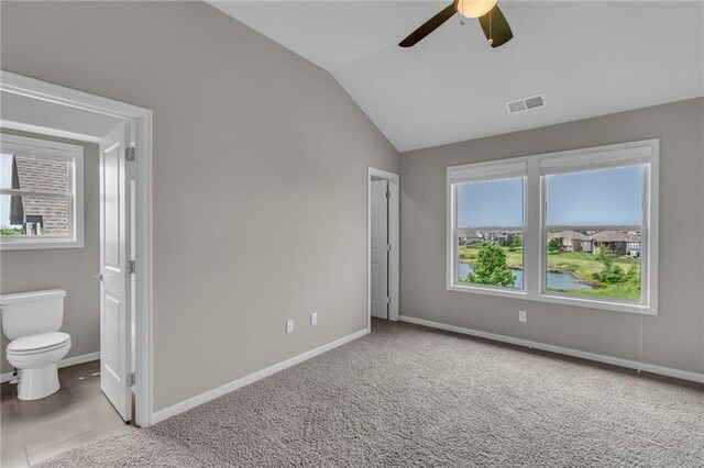 9812 Saddletop St, Lenexa, KS 66227 - unfurnished bedroom featuring vaulted ceiling, ensuite bathroom, ceiling fan, carpet, and a water view