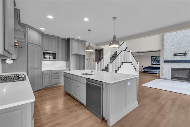 9812 Saddletop St, Lenexa, KS 66227 - kitchen with gray cabinetry, appliances with stainless steel finishes, light countertops, decorative backsplash, and recessed lighting