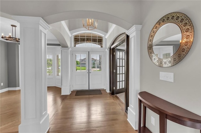 9812 Saddletop St, Lenexa, KS 66227 - entrance foyer with ornate columns, a chandelier, and arched walkways