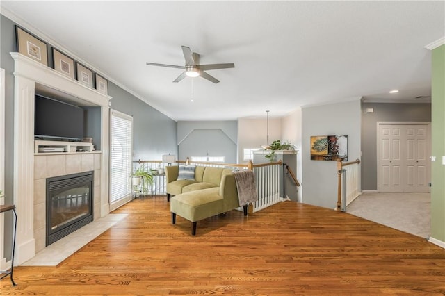 2420 SW Golden Eagle Rd, Lees Summit, MO 64082 - living room with ceiling fan, light wood-style floors, a fireplace, ornamental molding, and baseboards