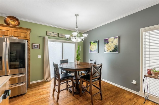 2420 SW Golden Eagle Rd, Lees Summit, MO 64082 - dining space with a chandelier, crown molding, light wood-style floors, and baseboards