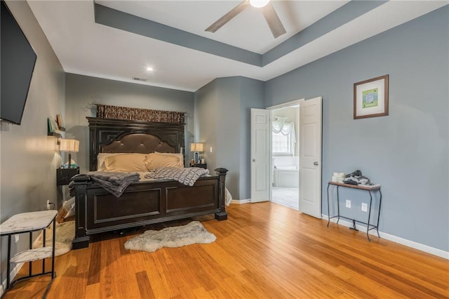 2420 SW Golden Eagle Rd, Lees Summit, MO 64082 - bedroom featuring wood finished floors, baseboards, a raised ceiling, and ensuite bathroom