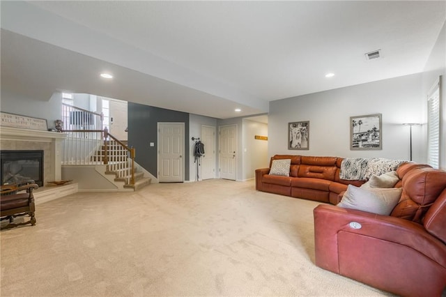 2420 SW Golden Eagle Rd, Lees Summit, MO 64082 - carpeted living area with recessed lighting, stairs, and a tiled fireplace