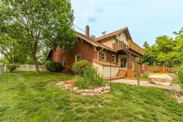 402 E Grand St, Gallatin, MO 64640 - back of property with a balcony, a chimney, a patio, brick siding, and a deck