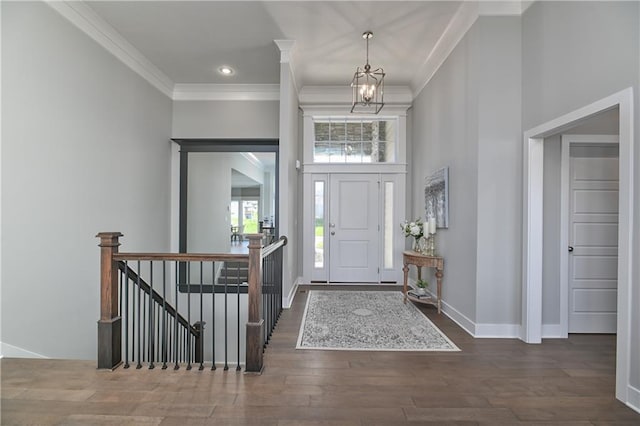 5858 Mccormick Dr, Shawnee, KS 66226 - entryway with a chandelier, a high ceiling, wood finished floors, crown molding, and baseboards