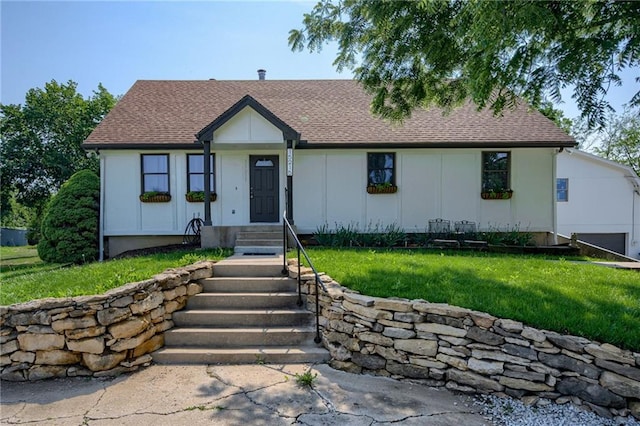 15215 Edgerton Rd, Gardner, KS 66030 - view of front of house featuring a shingled roof, a front yard, and board and batten siding
