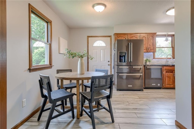 15215 Edgerton Rd, Gardner, KS 66030 - dining room featuring healthy amount of natural light, wood finish floors, and baseboards