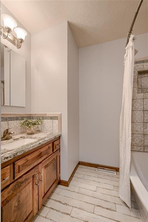 15215 Edgerton Rd, Gardner, KS 66030 - bathroom featuring vanity, a textured ceiling, shower / bath combo, and a chandelier