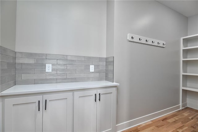 6031 Apache St, Shawnee, KS 66226 - detailed view of wood finished floors, tasteful backsplash, and baseboards
