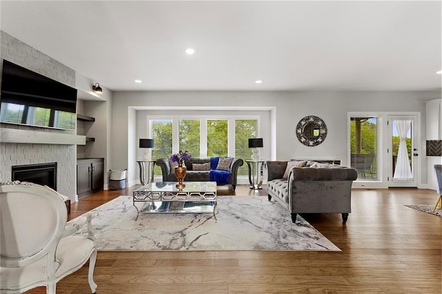 4820 NE 90th Ter, Kansas City, MO 64156 - living area with a large fireplace, plenty of natural light, built in features, recessed lighting, and wood finished floors