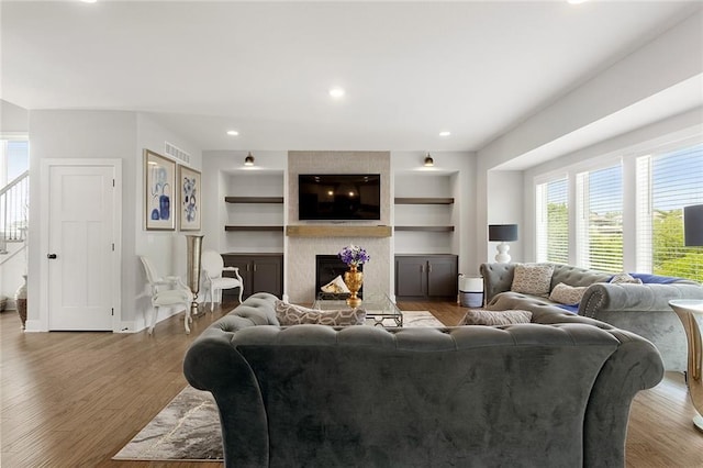 4820 NE 90th Ter, Kansas City, MO 64156 - living area featuring healthy amount of natural light, a fireplace, built in shelves, and recessed lighting
