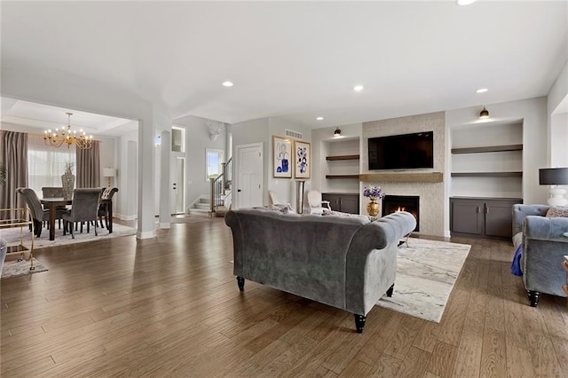 4820 NE 90th Ter, Kansas City, MO 64156 - living room featuring a chandelier, a fireplace, stairs, wood finished floors, and recessed lighting
