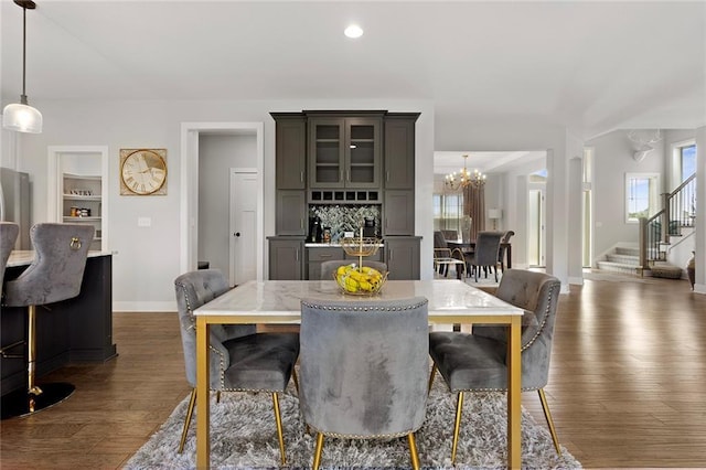 4820 NE 90th Ter, Kansas City, MO 64156 - dining room featuring stairs, a chandelier, dark wood-style floors, recessed lighting, and built in features