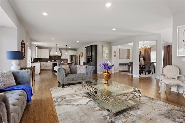 4820 NE 90th Ter, Kansas City, MO 64156 - living room with a chandelier, light wood finished floors, and recessed lighting