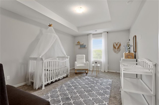 4820 NE 90th Ter, Kansas City, MO 64156 - bedroom featuring carpet flooring, a raised ceiling, and a nursery area
