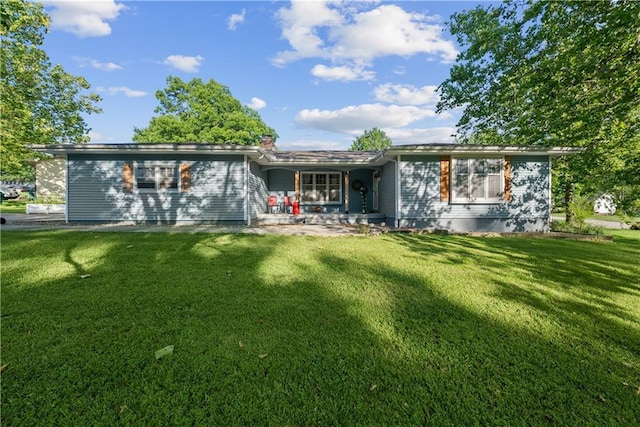 513 Brown Circle Dr, Osawatomie, KS 66064 - rear view of property with a yard and covered porch