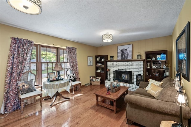 513 Brown Circle Dr, Osawatomie, KS 66064 - living area with a textured ceiling, a fireplace, and wood finished floors