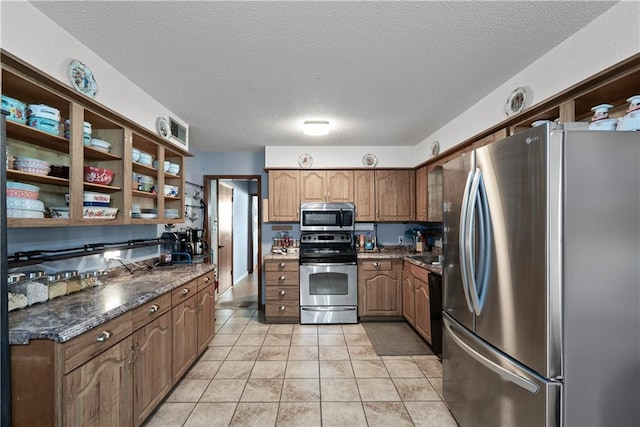 513 Brown Circle Dr, Osawatomie, KS 66064 - kitchen featuring stainless steel appliances, open shelves, a textured ceiling, and light tile patterned floors