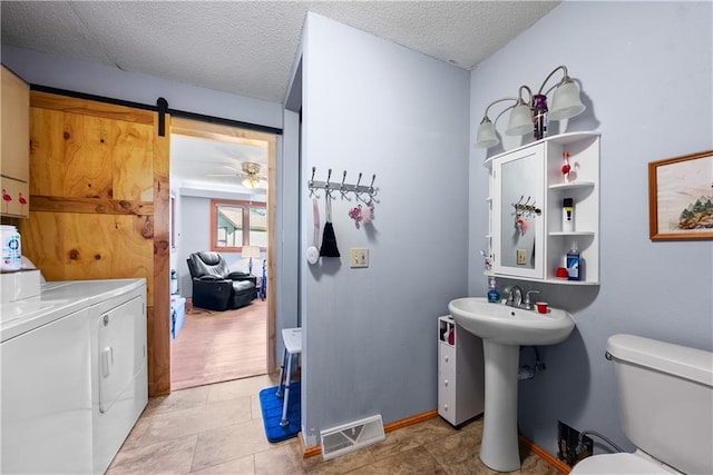 513 Brown Circle Dr, Osawatomie, KS 66064 - half bath with washer and clothes dryer, a textured ceiling, tile patterned flooring, and ceiling fan