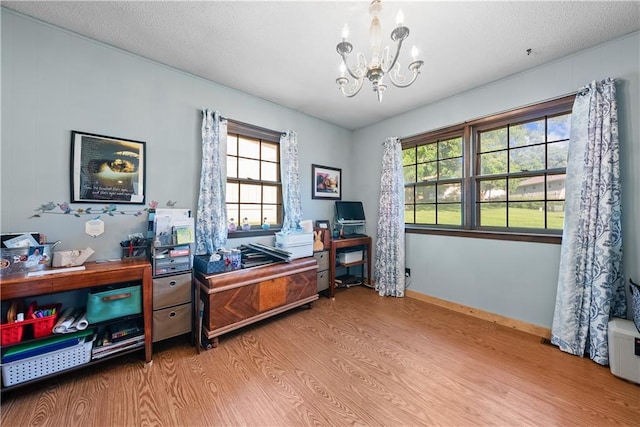 513 Brown Circle Dr, Osawatomie, KS 66064 - office area with wood finished floors, a chandelier, healthy amount of natural light, and a textured ceiling