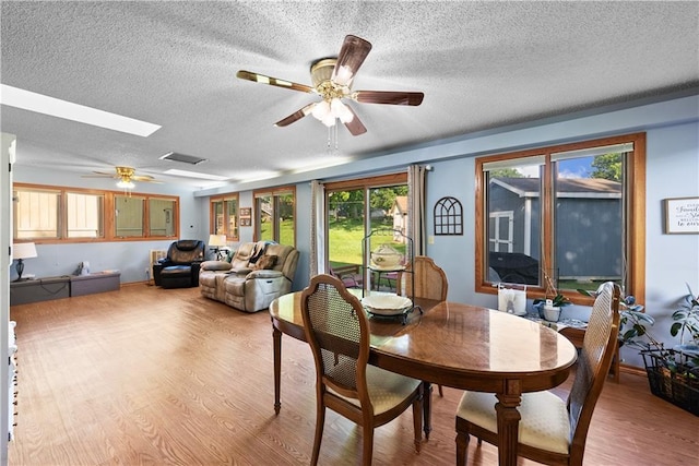 513 Brown Circle Dr, Osawatomie, KS 66064 - dining space with a ceiling fan, wood finished floors, and a textured ceiling
