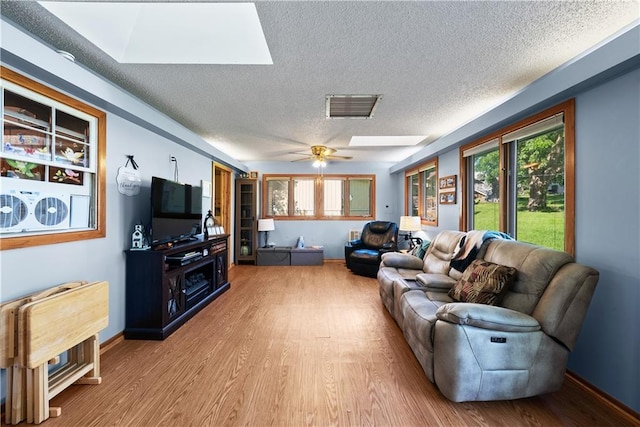 513 Brown Circle Dr, Osawatomie, KS 66064 - living area with a textured ceiling, a skylight, and wood finished floors