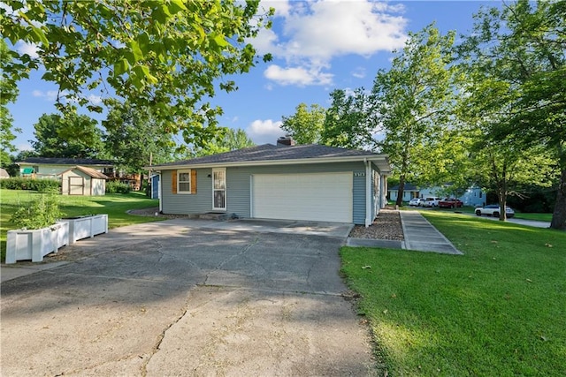 513 Brown Circle Dr, Osawatomie, KS 66064 - view of front of house with a storage unit, a front yard, a garage, concrete driveway, and a chimney