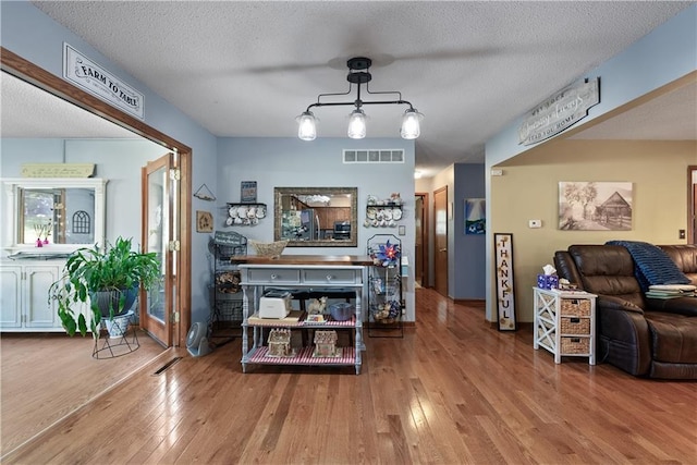 513 Brown Circle Dr, Osawatomie, KS 66064 - living area featuring hardwood / wood-style flooring and a textured ceiling
