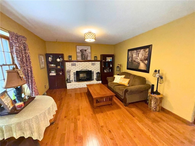 513 Brown Circle Dr, Osawatomie, KS 66064 - living area featuring light wood-style flooring and a brick fireplace