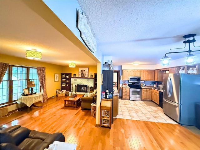 513 Brown Circle Dr, Osawatomie, KS 66064 - living room with light wood finished floors, a textured ceiling, and a fireplace