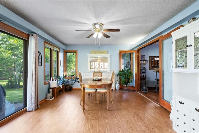 513 Brown Circle Dr, Osawatomie, KS 66064 - dining room with ceiling fan, a textured ceiling, and wood finished floors
