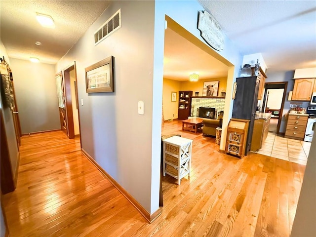 513 Brown Circle Dr, Osawatomie, KS 66064 - hallway with light wood-style floors and a textured ceiling