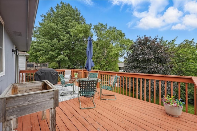 1453 Madison St, Lees Summit, MO 64081 - wooden deck with outdoor dining space and a grill